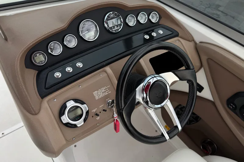 Slide: The Image of Dashboard of a 2012 Cobalt 262 WSS boat with steering wheel and gauges. - 43