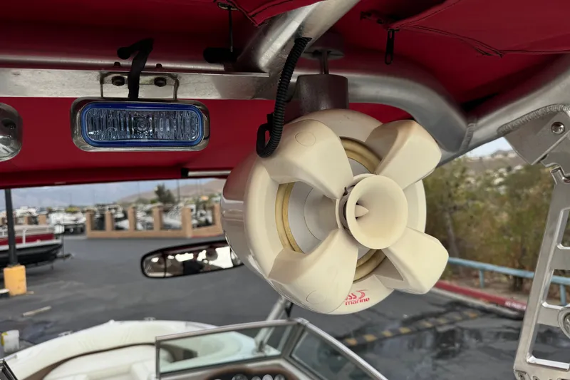 Slide: The Image of 2012 Cobalt 262 WSS boat with speaker and blue light under red canopy. - 23