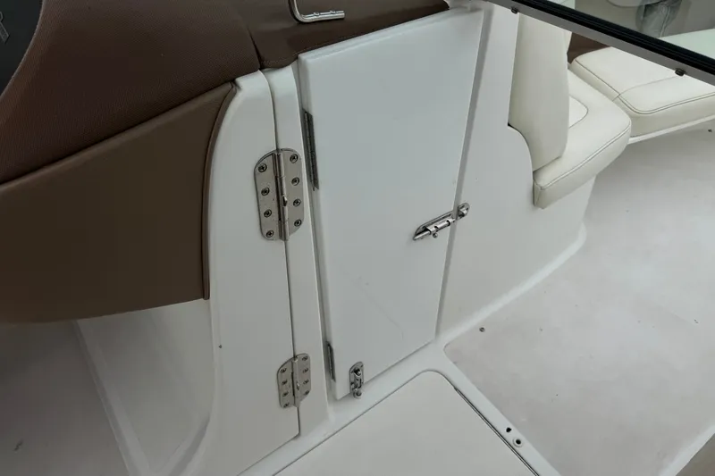 Slide: The Image of Interior view of a 2012 Cobalt 262 WSS boat, featuring white seating and cabinetry. - 40