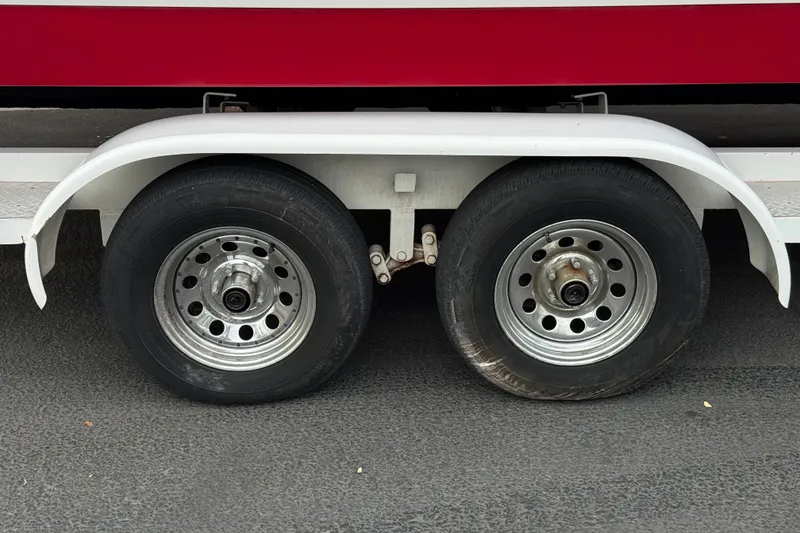 Slide: The Image of Trailer wheels of a 2012 Cobalt 262 WSS boat on asphalt surface. - 45