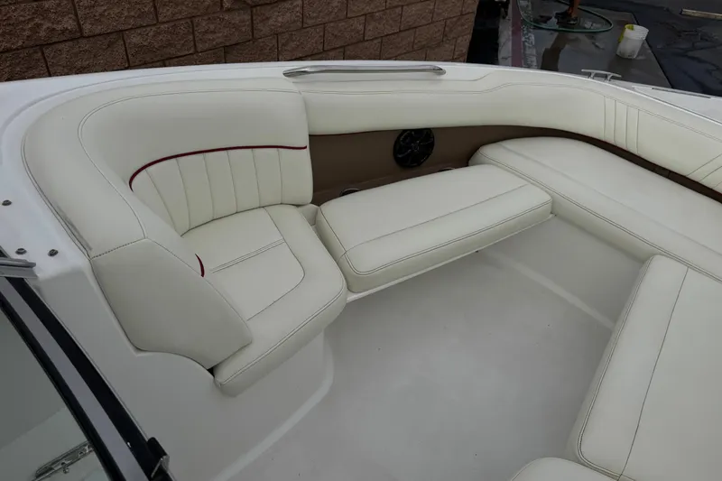 Slide: The Image of Luxurious white seating in a 2012 Cobalt 262 WSS boat interior. - 16