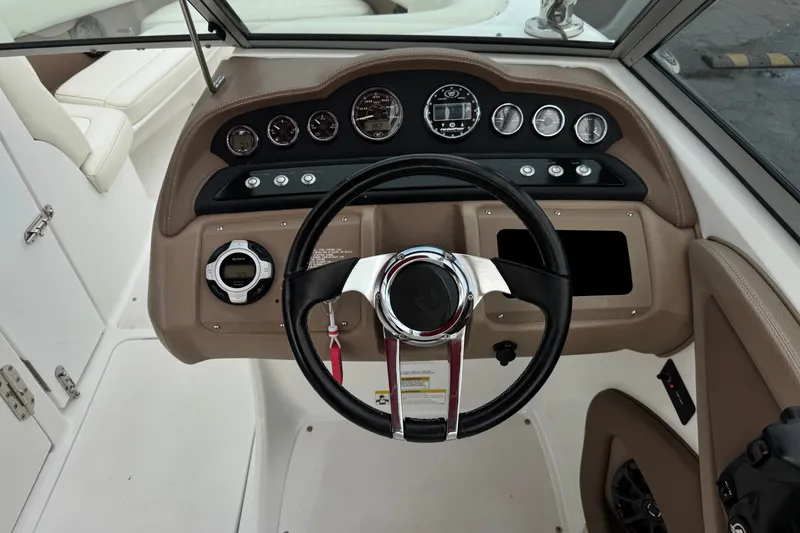 Slide: The Image of Steering console of a 2012 Cobalt 262 WSS boat with gauges and controls. - 42