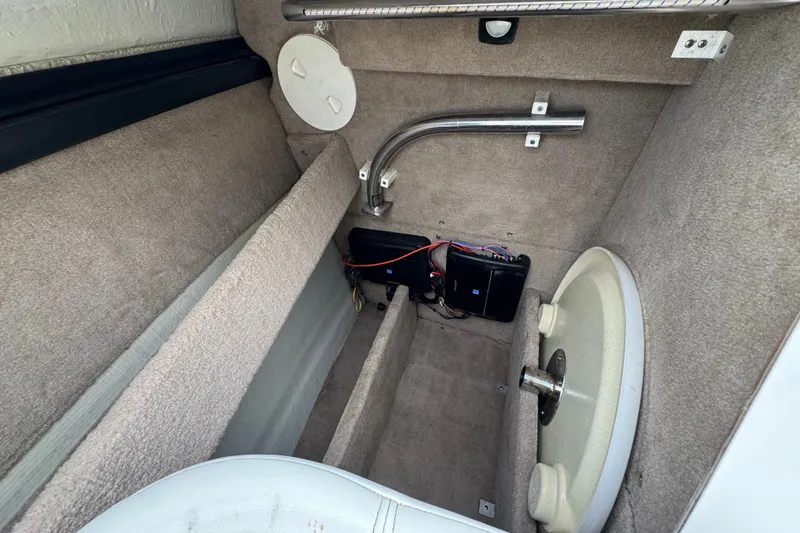Slide: The Image of Interior view of a 2012 Cobalt 262 WSS boat compartment with wiring and storage. - 19