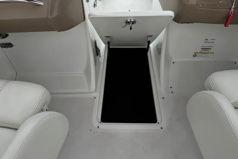 Slide: The Image of 2012 Cobalt 262 WSS boat interior with open storage compartment and white seating. - 39