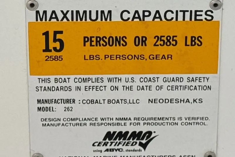 Slide: The Image of 2012 Cobalt 262 WSS boat capacity label: 15 persons or 2585 lbs, NMMA certified. - 49