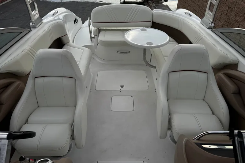 Slide: The Image of Luxurious interior of a 2012 Cobalt 262 WSS boat with white seating and table. - 25