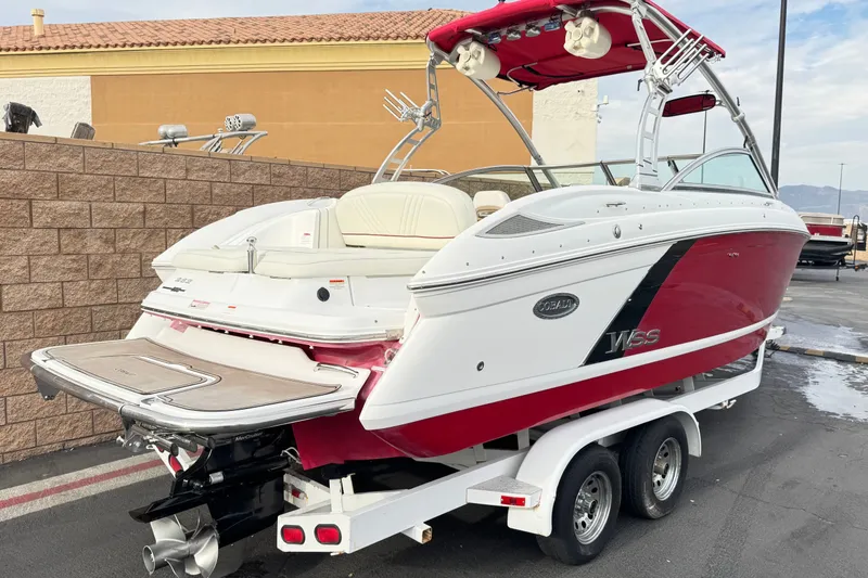 Slide: The Image of 2012 Cobalt 262 WSS boat with red and white design on a trailer. - 47