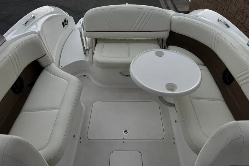 Slide: The Image of Interior of a 2012 Cobalt 262 WSS boat with white seating and round table. - 26