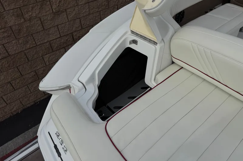 Slide: The Image of 2012 Cobalt 262 WSS boat interior with white seating and storage compartment. - 7