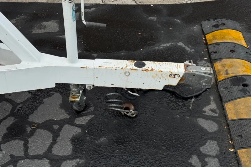 Slide: The Image of Trailer hitch of a 2012 Cobalt 262 WSS on wet asphalt near a speed bump. - 46