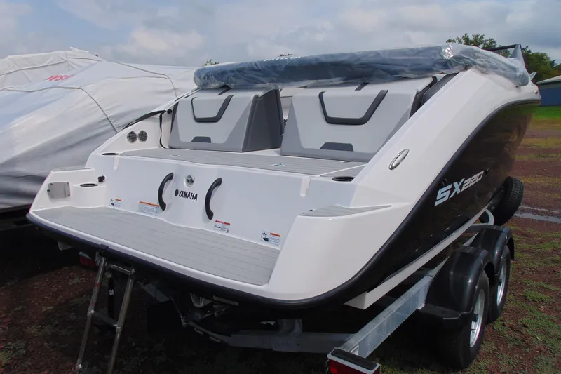 Slide: The Image of 2026 Yamaha Boats SX220 on trailer, rear view, showcasing sleek design and modern features. - 5
