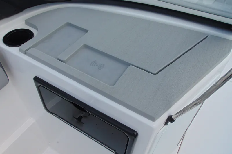 Slide: The Image of 2026 Yamaha Boats SX220 dashboard with wireless charging pad and cup holder. - 11