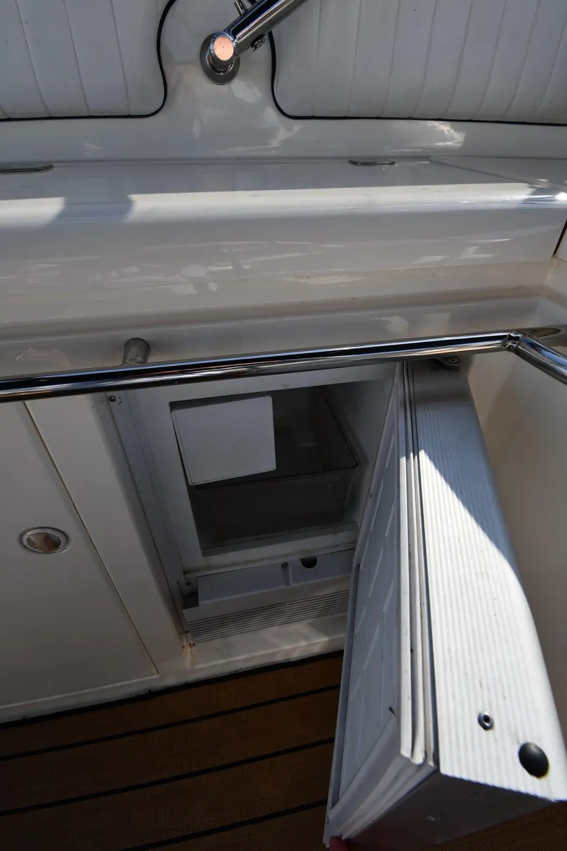 Slide: The Image of Open refrigerator on 1996 Sunseeker 55 CAMARGUE yacht, showcasing interior storage space. - 33