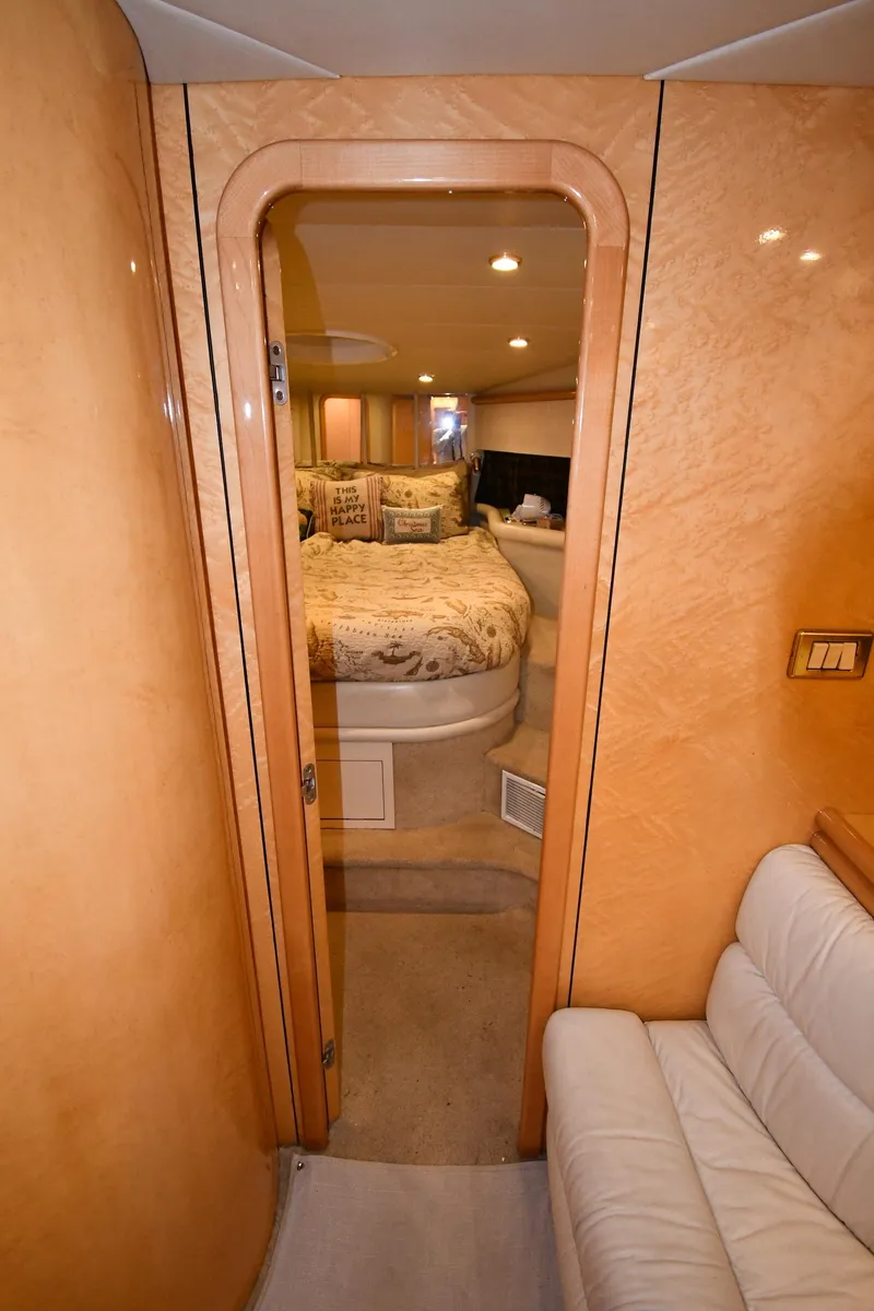 Slide: The Image of Interior of 1996 Sunseeker 55 CAMARGUE yacht, featuring a cozy bedroom and elegant wood paneling. - 39