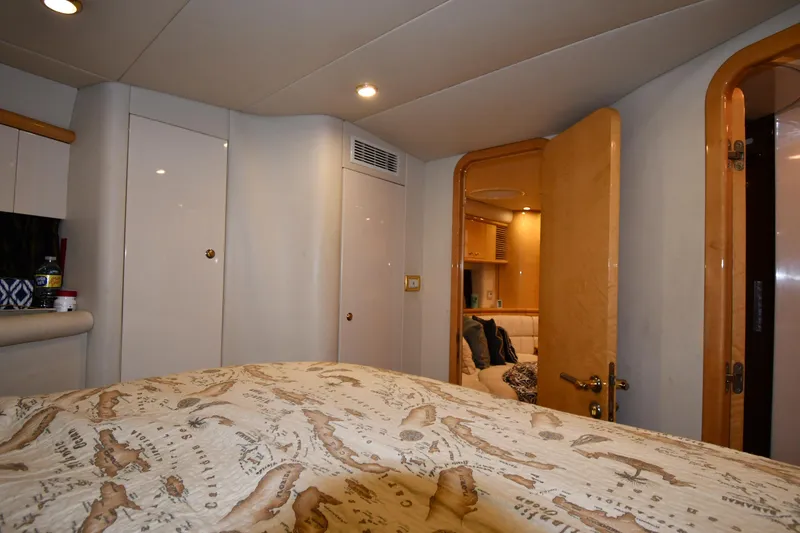 Slide: The Image of Interior of 1996 Sunseeker 55 CAMARGUE yacht, featuring cozy cabin with elegant wood finishes. - 44