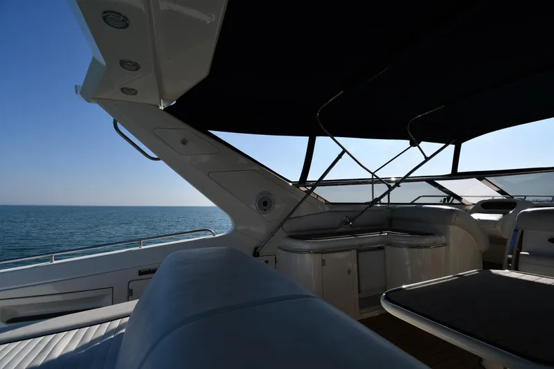 Slide: The Image of Sunseeker 55 CAMARGUE 1996 yacht interior with ocean view, featuring sleek design and comfortable seating. - 26