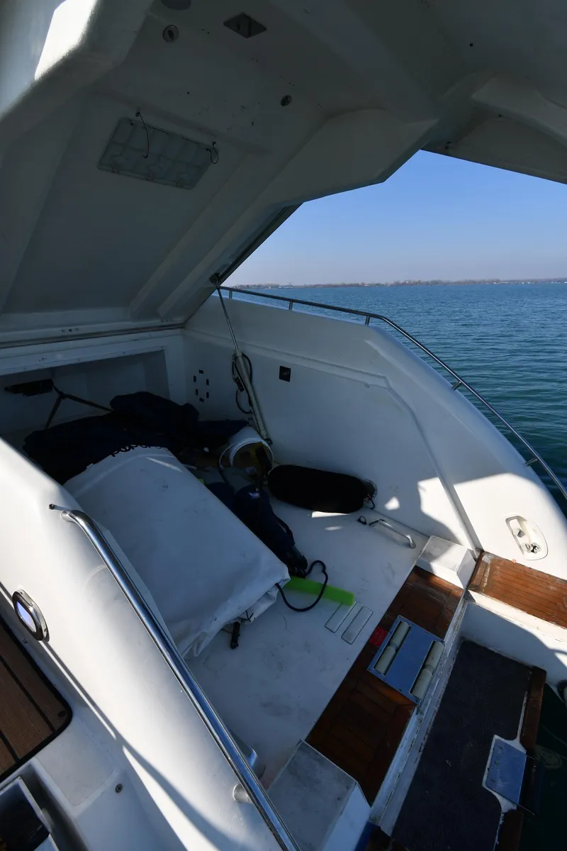 Slide: The Image of 1996 Sunseeker 55 CAMARGUE yacht interior with open hatch, overlooking calm sea. - 36