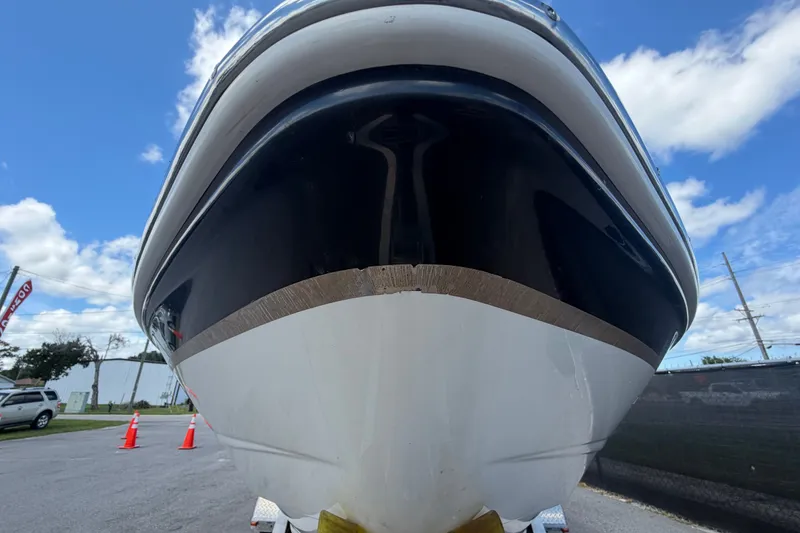 Slide: The Image of Front view of a 2003 Chaparral 183 SS boat on a trailer under a blue sky. - 9