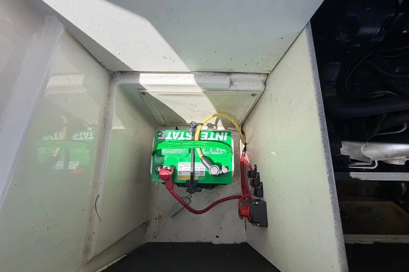Slide: The Image of Battery compartment of a 2003 Chaparral 183 SS boat with visible wiring. - 55