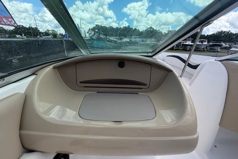Slide: The Image of 2003 Chaparral 183 SS boat interior with windshield and seating, under a cloudy sky. - 30