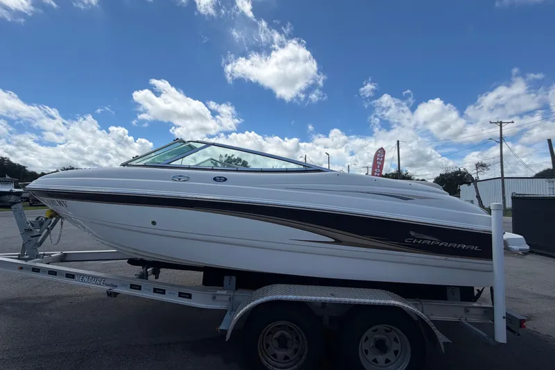 Slide: The Image of 2003 Chaparral 183 SS boat on trailer under a partly cloudy sky. - 7