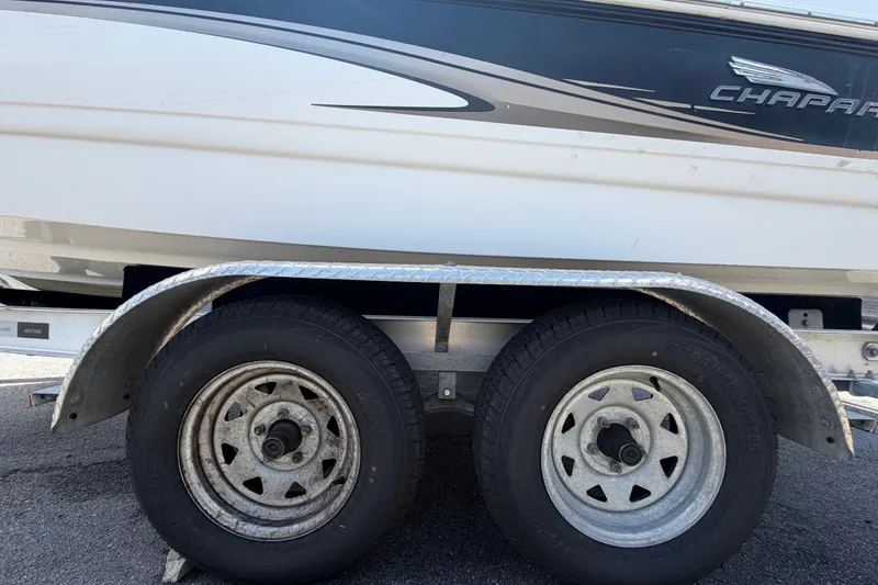Slide: The Image of Trailer wheels of a 2003 Chaparral 183 SS boat on pavement. - 68