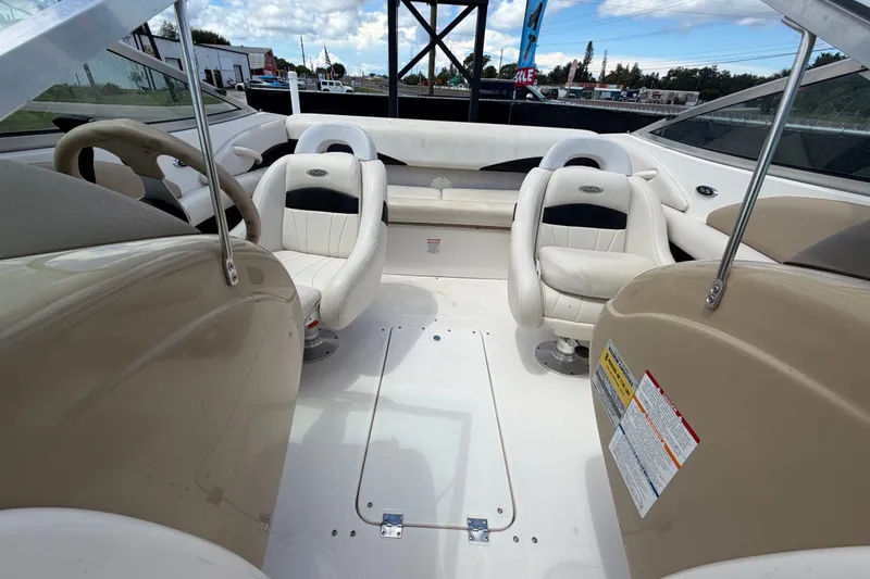 Slide: The Image of 2003 Chaparral 183 SS boat interior with white seating and steering wheel. - 47