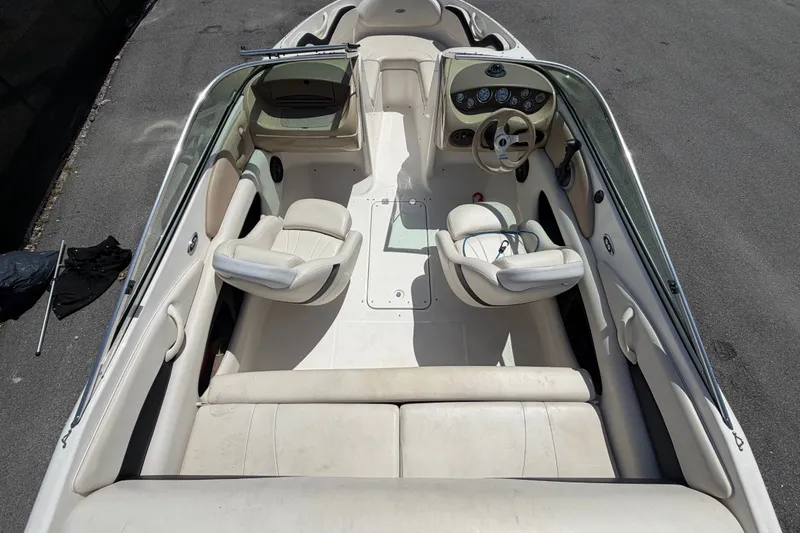 Slide: The Image of 2003 Chaparral 183 SS boat interior with white seating and steering console. - 13