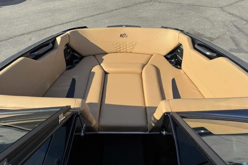 Slide: The Image of 2027 MasterCraft NXT22 boat interior with tan seating and modern design. - 14