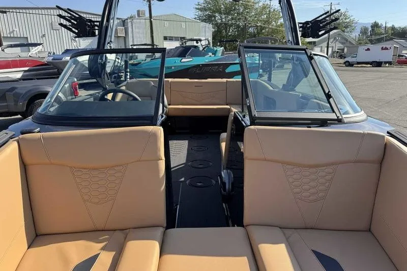 Slide: The Image of 2027 MasterCraft NXT22 boat interior with tan seating and open windshield. - 15