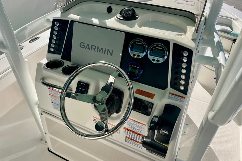 Slide: The Image of 2027 Robalo 226 Cayman boat dashboard with Garmin navigation system and Yamaha controls. - 16