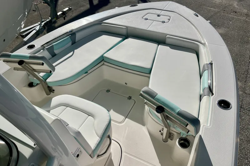 Slide: The Image of 2027 Robalo 226 Cayman boat interior with cushioned seating and rod holders. - 20