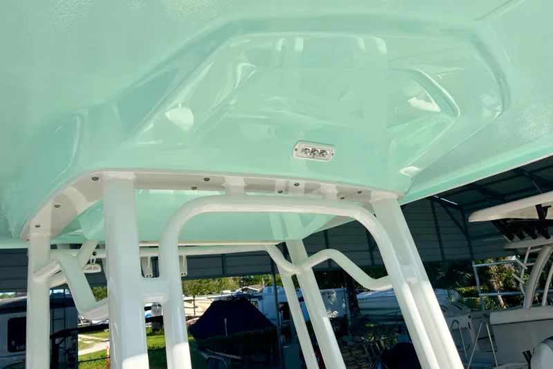 Slide: The Image of T-top structure of 2027 Robalo 226 Cayman boat in a light blue finish. - 25
