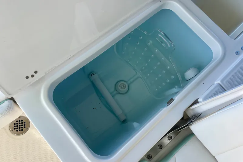 Slide: The Image of Livewell compartment on a 2027 Robalo 226 Cayman boat, filled with water. - 11