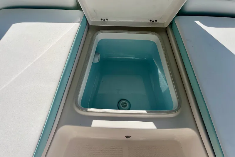 Slide: The Image of Livewell compartment on a 2027 Robalo 226 Cayman boat, featuring cushioned seating. - 22