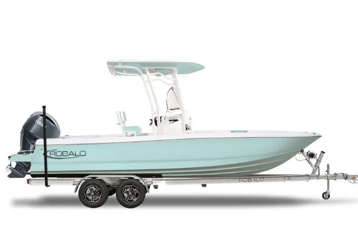 The Image of 2027 Robalo 226 Cayman boat on trailer, side view, light blue hull. - 1