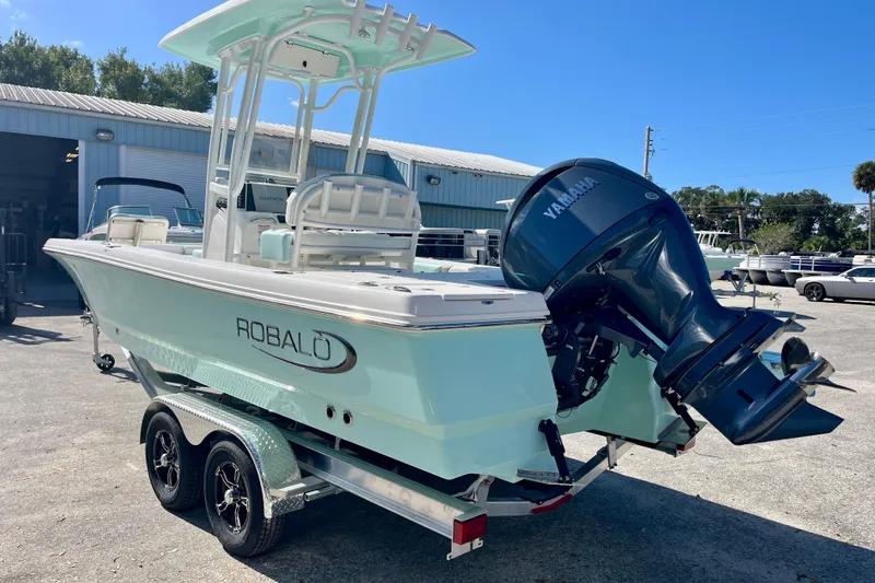 Slide: The Image of 2027 Robalo 226 Cayman boat with Yamaha engine on trailer, parked outdoors. - 8