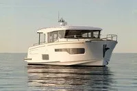 The Image of Nimbus 495 Coupe 2027 yacht cruising on calm waters at sunset. - 1