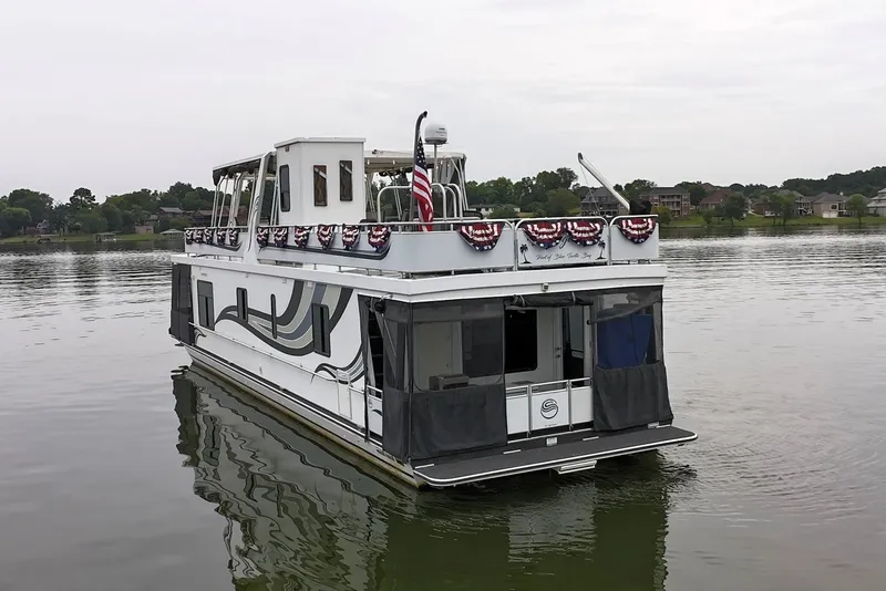 Slide: The Image of 2005 Sumerset houseboat on calm lake, decorated with patriotic bunting. - 8