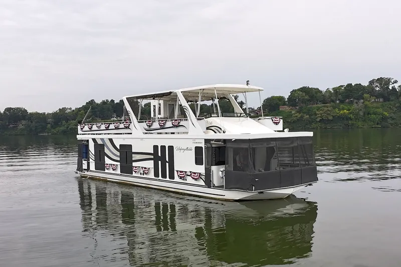 Slide: The Image of 2005 Sumerset 16'6" X 63 houseboat on a calm lake with scenic background. - 17
