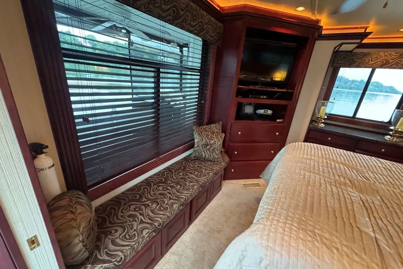 Slide: The Image of Luxurious 2005 Sumerset houseboat interior with elegant wood finishes and scenic window views. - 80