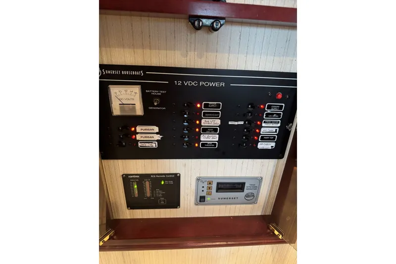Slide: The Image of Control panel of a 2005 Sumerset 16'6" X 63 houseboat, featuring 12 VDC power system. - 103
