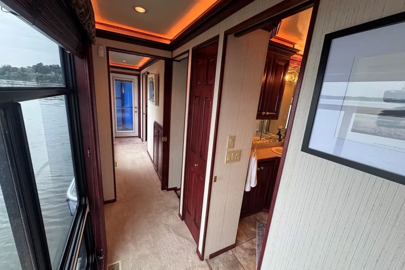 Slide: The Image of Luxurious 2005 Sumerset houseboat interior with elegant wood finishes and scenic water views. - 65
