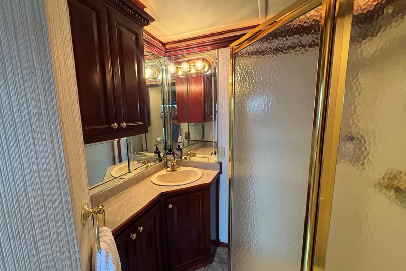 Slide: The Image of Luxurious bathroom in 2005 Sumerset houseboat with wooden cabinets and glass shower. - 67