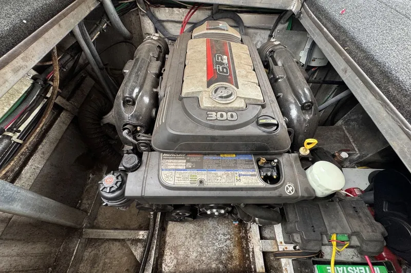 Slide: The Image of Engine compartment of a 2005 Sumerset 16'6" X 63 houseboat, featuring a Mercury 300 engine. - 99
