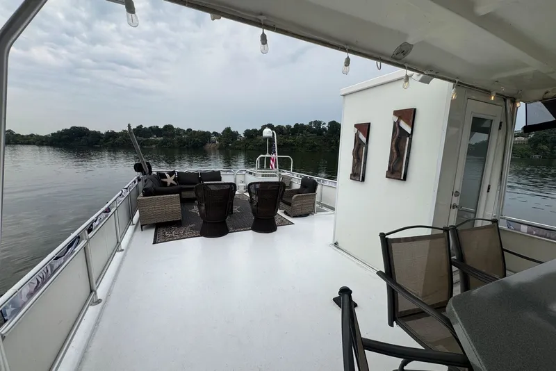 Slide: The Image of Spacious deck of 2005 Sumerset houseboat with outdoor seating and scenic lake view. - 32