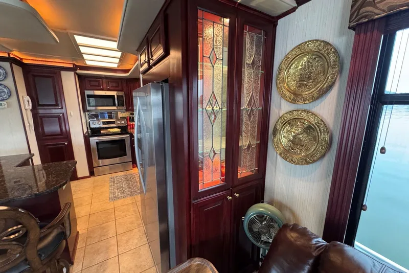 Slide: The Image of Luxurious kitchen interior of a 2005 Sumerset houseboat with elegant wood cabinetry. - 52