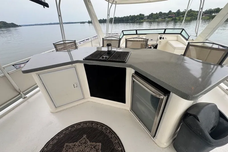 Slide: The Image of Outdoor kitchen on 2005 Sumerset houseboat with grill, fridge, and lake view. - 30