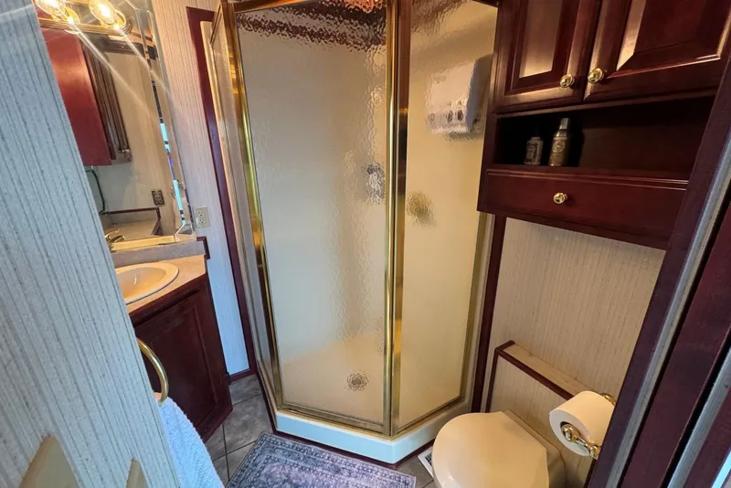 Slide: The Image of Luxurious bathroom in 2005 Sumerset houseboat with shower, sink, and wooden cabinetry. - 66