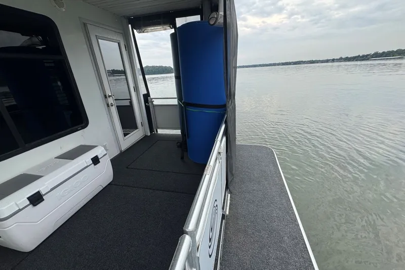 Slide: The Image of 2005 Sumerset houseboat deck with cooler, overlooking calm waters. - 98